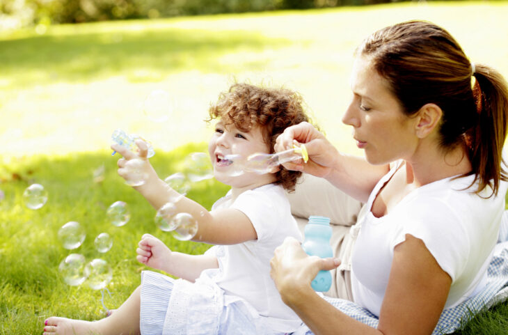 mother and child blowing bubbles
