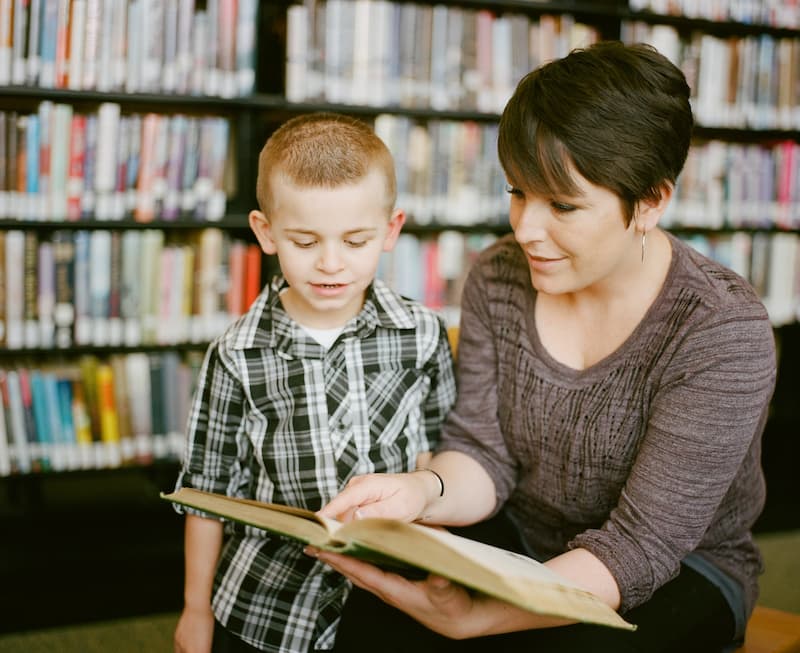 teacher and boy in the library teacher and boy in the library
