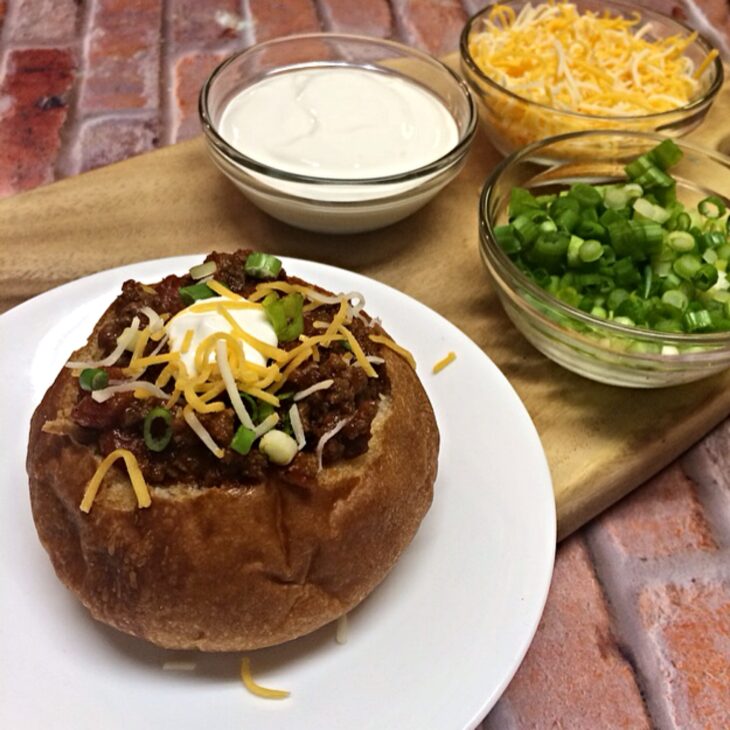slow cooker chili in a bread bowl