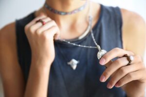 woman wearing layered necklaces