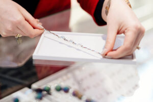 woman at a jewelry store looking at a bracelet