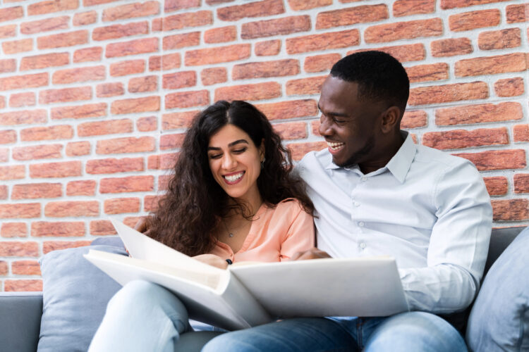 couple looking at wedding album couple looking at wedding album