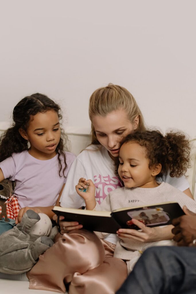 mother and children looking at photo book mother and children looking at photo book