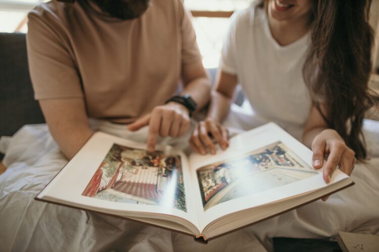 couple looking at a photo book couple looking at a photo book
