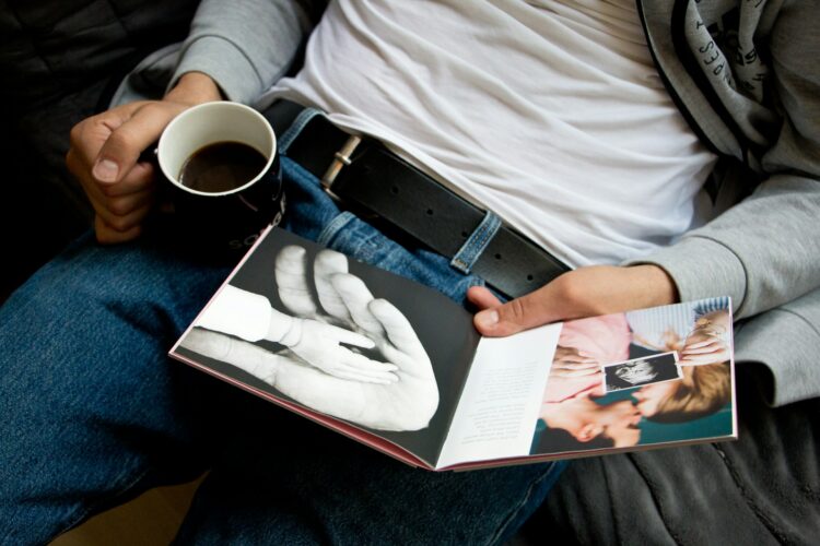 man looking at a photo book man looking at a photo book