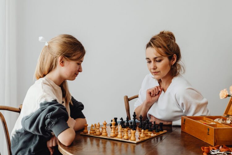 How to Stay Close to Your Teen When They'd Rather Text Than Talk 2 pexels mother mom teen girl chess board game