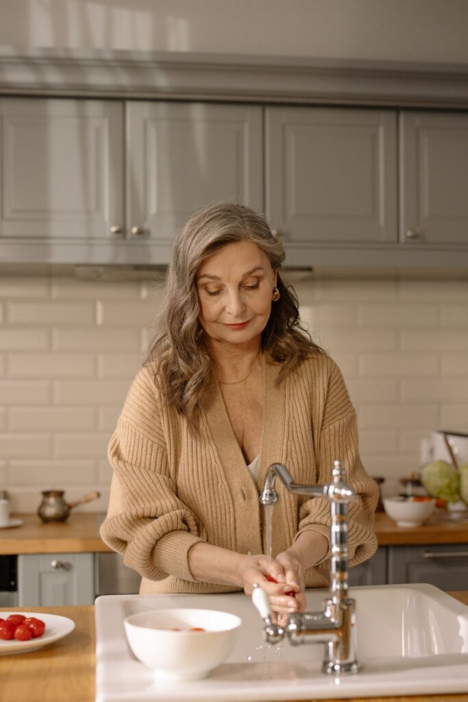 woman at the kitchen sink woman at the kitchen sink